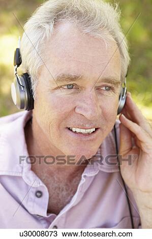 Stock Image - Senior man with headphone. Fotosearch