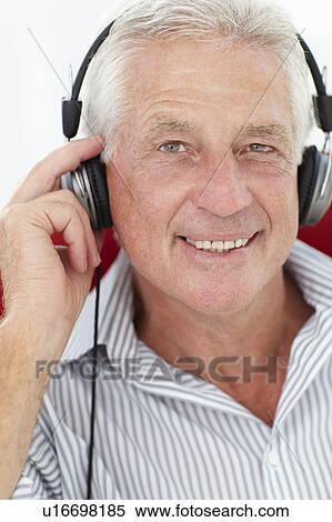 Stock Photography - Senior man with headphones. Fotosearch
