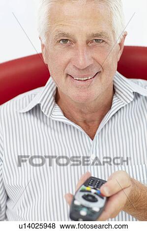 Senior man with remote control View Large Photo Image Stock Photo - Senior man with remote control. Fotosearch