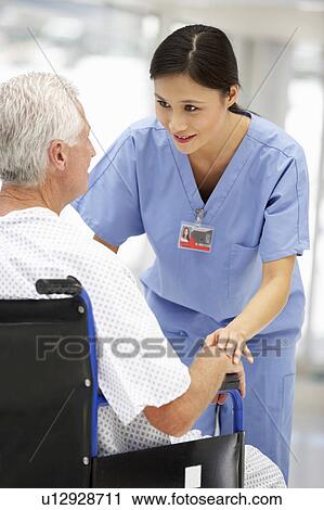 Stock Image - Senior patient with young doctor. Fotosearch