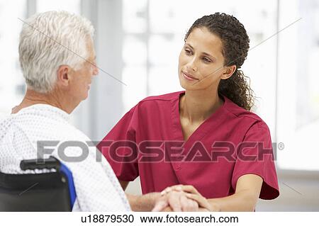 Stock Image - Senior patient with young doctor. Fotosearch