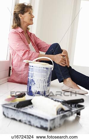 Picture - Senior woman decorating house. Fotosearch