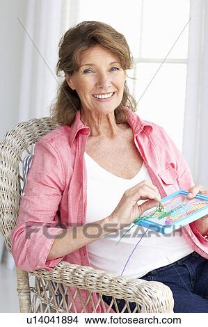 Senior woman doing cross stitch View Large Photo Image Picture - Senior woman doing cross stitch. Fotosearch