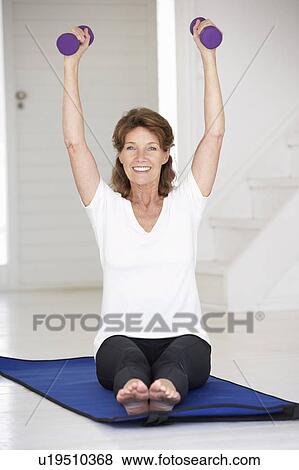 Senior woman exercising at home View Large Photo Image Stock Photo - Senior woman exercising at home. Fotosearch