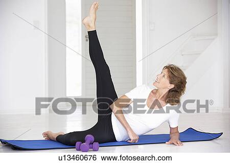 Senior woman exercising in home gym View Large Photo Image Stock Photograph - Senior woman exercising in home gym. Fotosearch