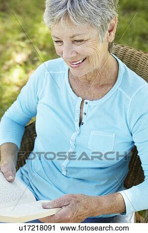 Senior woman reading a book View Large Photo Image Stock Image - Senior woman reading a book. Fotosearch