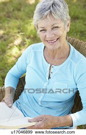Stock Photo - Senior woman reading a book. Fotosearch