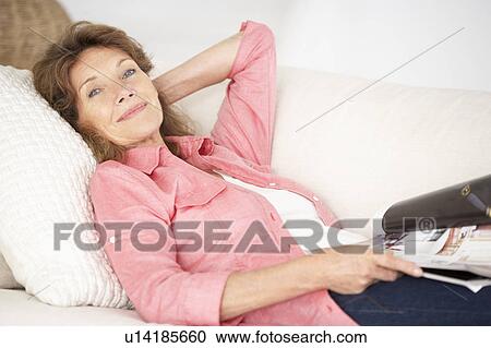 Stock Image - Senior woman relaxing at home. Fotosearch