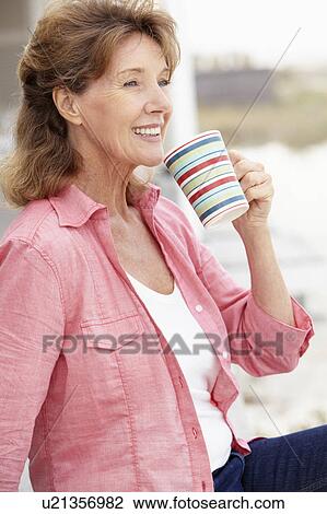Senior woman relaxing outdoors View Large Photo Image Stock Image - Senior woman relaxing outdoors. Fotosearch