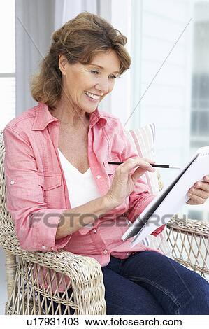 Stock Image - Senior woman sketching. Fotosearch