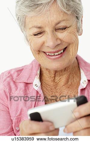 Stock Photo - Senior woman using mobile phone. Fotosearch