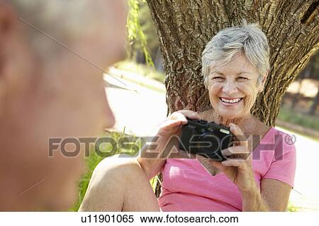 Stock Photography - Senior woman with camera. Fotosearch