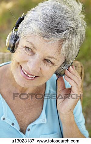 Senior woman with headphone View Large Photo Image Stock Photo - Senior woman with headphone. Fotosearch