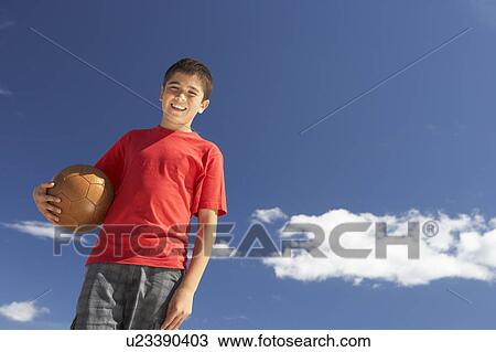 Teenage boy holding football View Large Photo Image Stock Image - Teenage boy holding football. Fotosearch