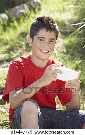 Teenage boy playing with computer game View Large Photo Image Stock Image - Teenage boy playing with computer game. Fotosearch
