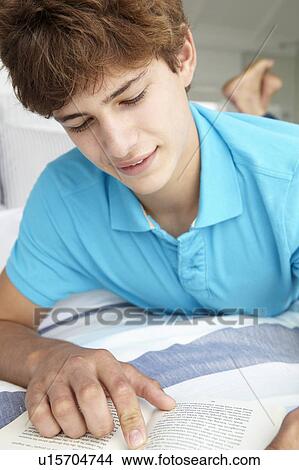 Teenage boy reading a book View Large Photo Image Picture - Teenage boy reading a book. Fotosearch