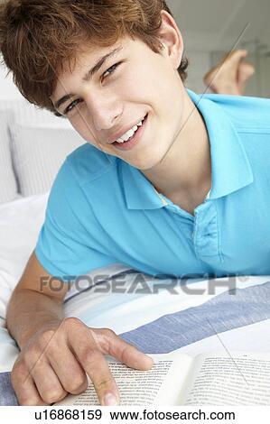 Teenage boy reading a book View Large Photo Image Stock Photo - Teenage boy reading a book. Fotosearch