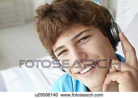 Teenage boy wearing headphones View Large Photo Image Stock Image - Teenage boy wearing headphones. Fotosearch
