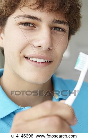 Stock Photograph - Teenage boy with toothbrush. Fotosearch