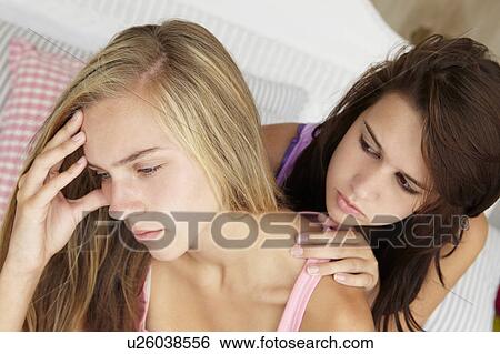 Teenage girl comforting friend View Large Photo Image Stock Photograph - Teenage girl comforting friend. Fotosearch
