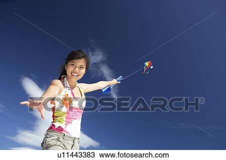 Teenage girl flying a kite View Large Photo Image Stock Image - Teenage girl flying a kite. Fotosearch