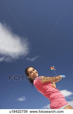 Teenage girl flying a kite View Large Photo Image Stock Photo - Teenage girl flying a kite. Fotosearch