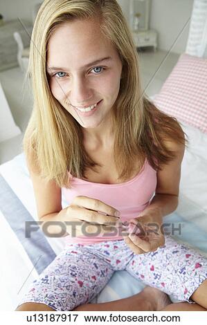 Teenage girl painting nails View Large Photo Image Stock Photo - Teenage girl painting nails. Fotosearch