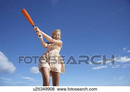 Stock Photo - Teenage girl playing baseball. Fotosearch