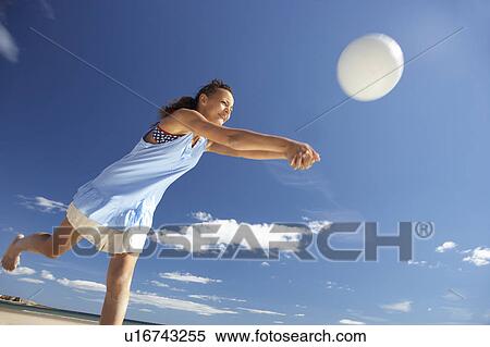 Teenage girl playing beach volleyball View Large Photo Image Stock Photography - Teenage girl playing beach volleyball. Fotosearch