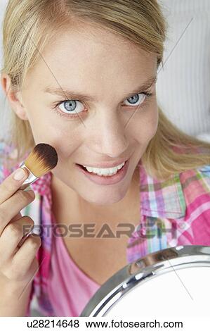 Teenage girl putting on make-up View Large Photo Image Stock Photo - Teenage girl putting on make-up. Fotosearch