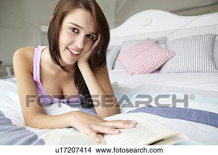 Picture - Teenage girl reading a book. Fotosearch