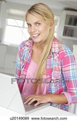 Teenage girl using laptop View Large Photo Image Stock Photo - Teenage girl using laptop. Fotosearch