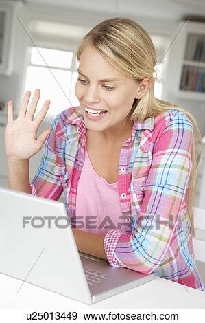 Stock Photo - Teenage girl using laptop. Fotosearch
