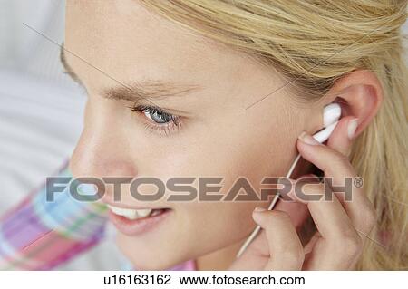 Stock Image - Teenage girl wearing earphones. Fotosearch