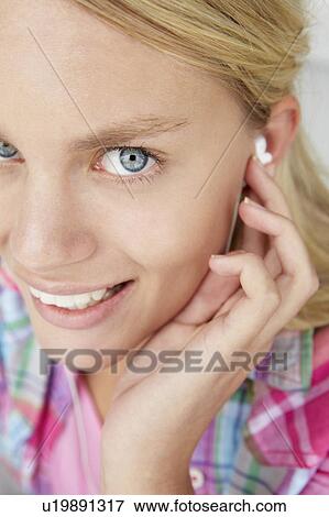 Stock Photo - Teenage girl wearing earphones. Fotosearch