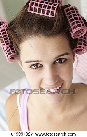 Teenage girl with hair in curlers View Large Photo Image Stock Photo - Teenage girl with hair in curlers. Fotosearch