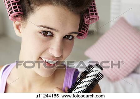 Stock Photography - Teenage girl with hair in curlers. Fotosearch