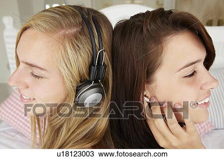 Teenage girls listening to music View Large Photo Image Stock Image - Teenage girls listening to music. Fotosearch