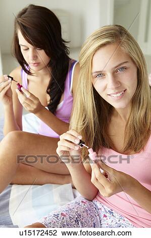Teenage girls painting nails View Large Photo Image Stock Image - Teenage girls painting nails. Fotosearch