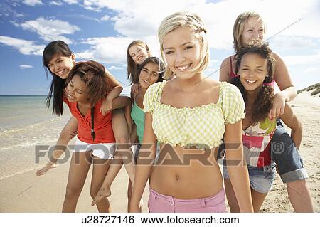 Teenage girls walking on beach View Large Photo Image Stock Photograph - Teenage girls walking on beach. Fotosearch