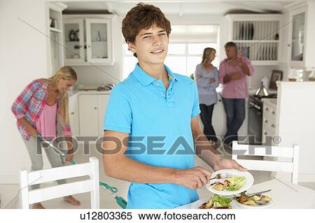 Teenagers helping with housework View Large Photo Image Stock Photography - Teenagers helping with housework. Fotosearch