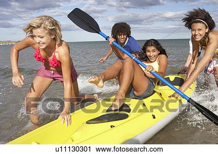 Teenagers in sea with canoe View Large Photo Image Stock Image - Teenagers in sea with canoe. Fotosearch