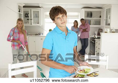 Stock Photograph - Teenagers not enjoying housework. Fotosearch