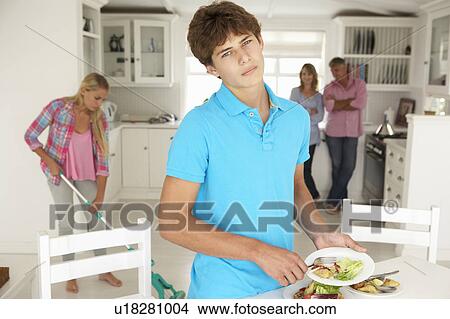 Teenagers reluctantly doing housework View Large Photo Image Picture - Teenagers reluctantly doing housework. Fotosearch