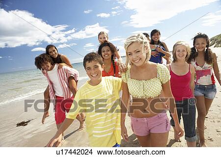 Teenagers walking on beach View Large Photo Image Picture - Teenagers walking on beach. Fotosearch