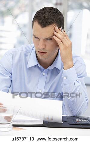 Stock Image - Thoughtful young businessman. Fotosearch