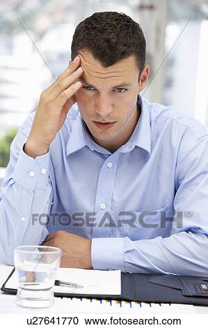 Stock Image - Thoughtful young businessman. Fotosearch