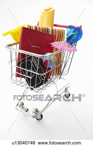 Stock Photo - Trolley full of items for holiday. Fotosearch