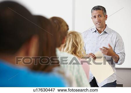Stock Photo - Tutor with class of students. Fotosearch