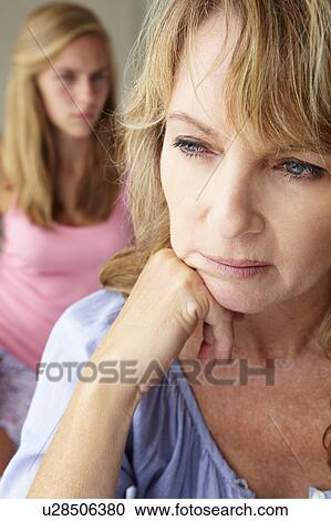 Stock Image - Unhappy mother with teenage girl. Fotosearch